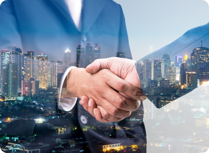 Two individuals shaking hands, superimposed on a city skyline at dusk.